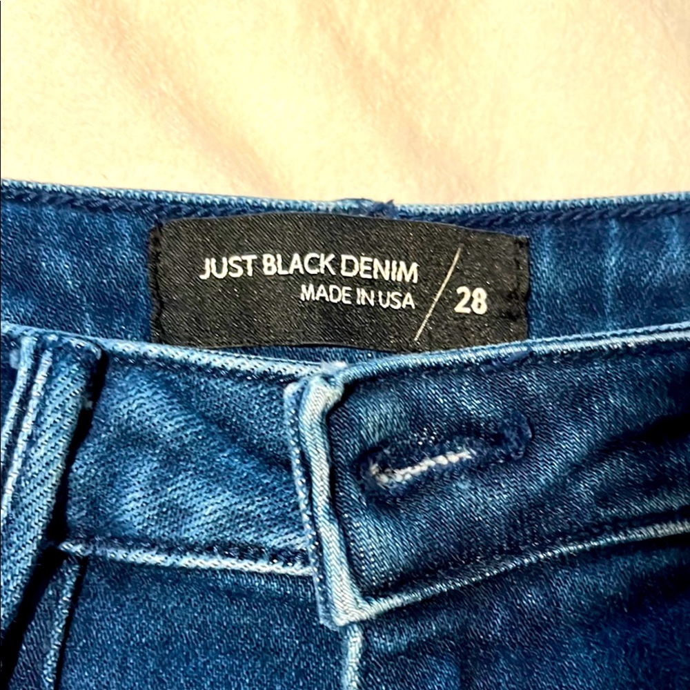 Just Black dark blue jeans with front pockets.